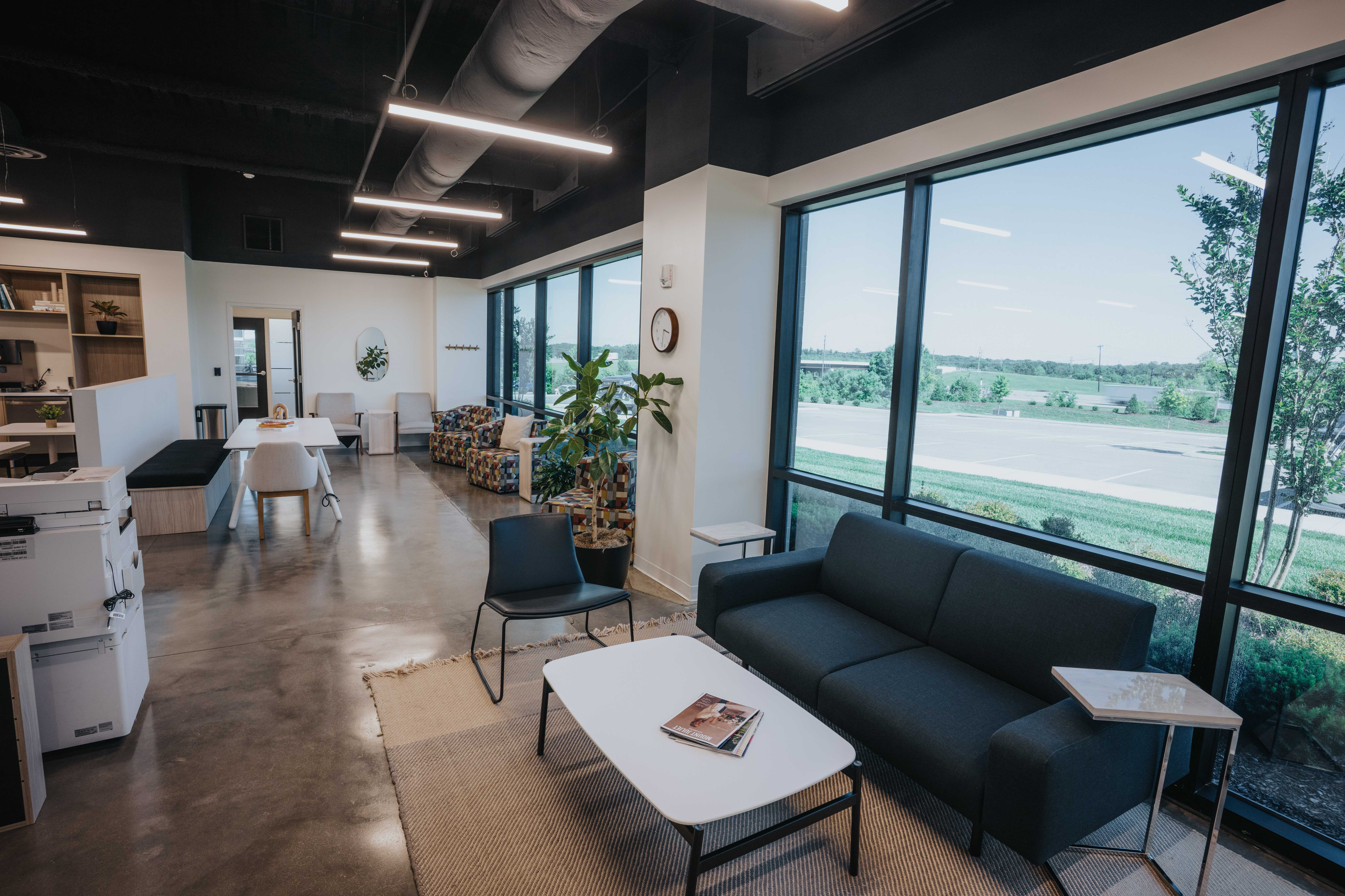 The bright Framework common area with a wall of windows