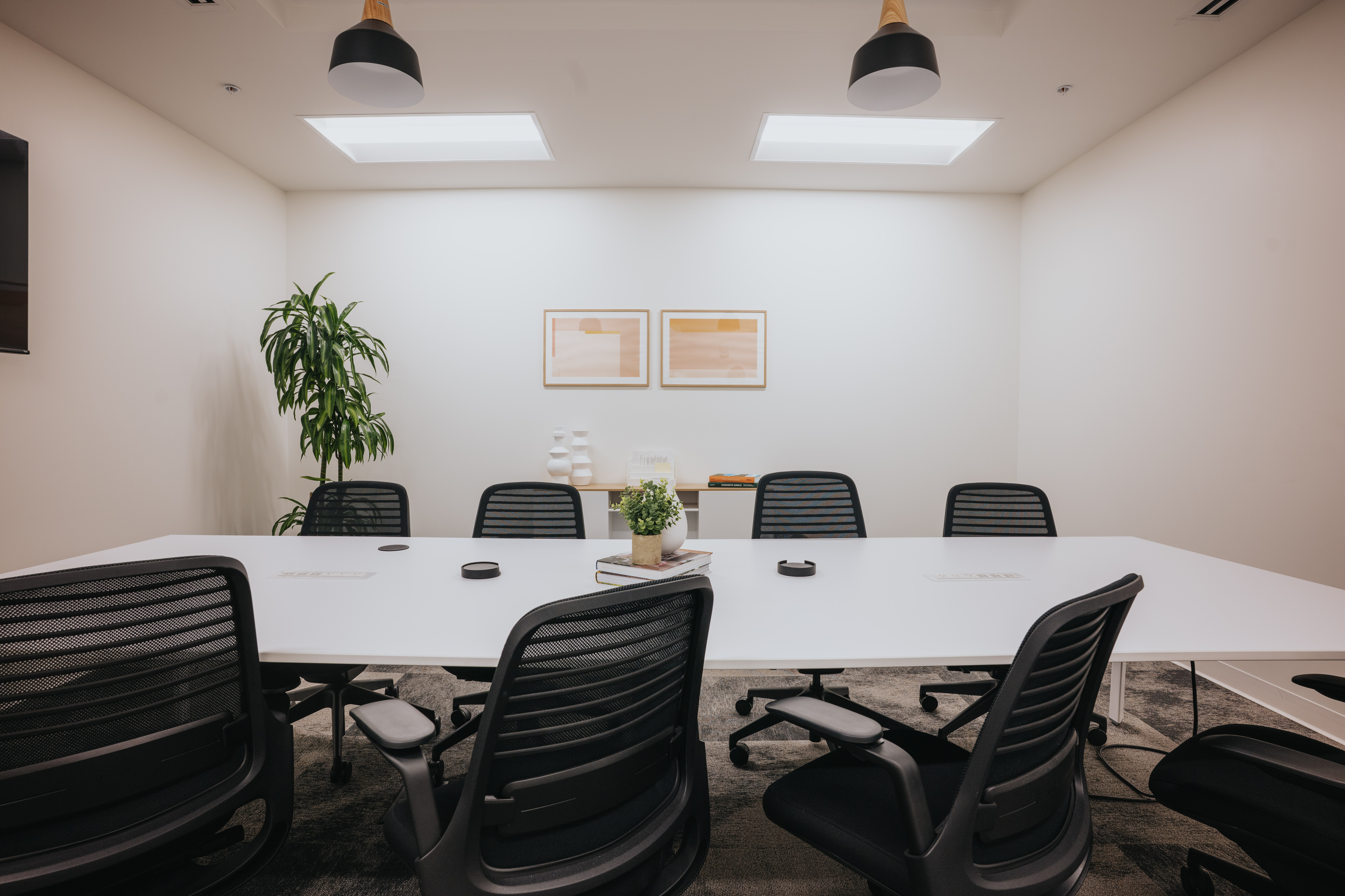 A Framework conference room with white table and natural light